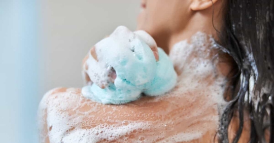 A woman exfoliating in the shower